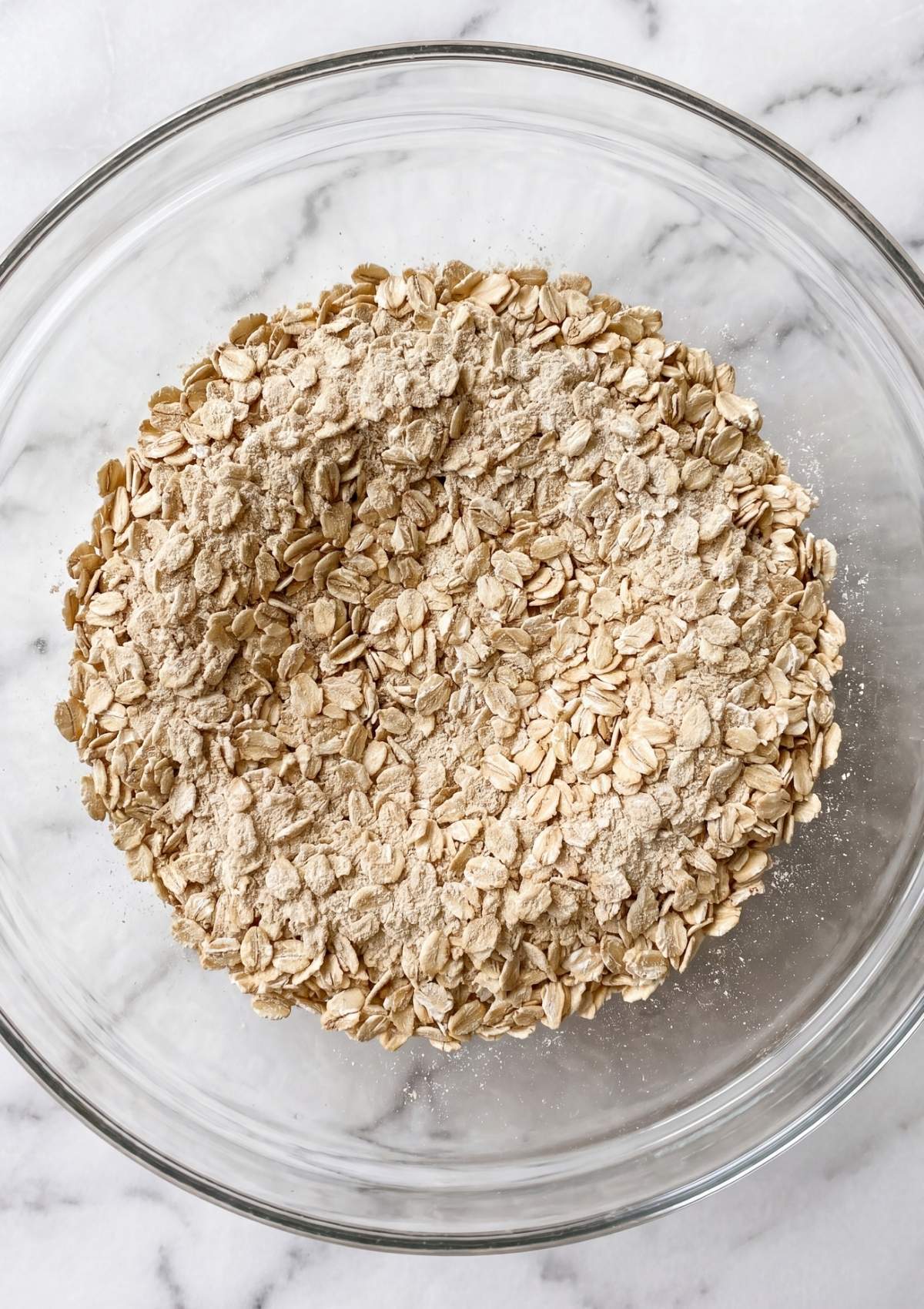 oats and protein powder in bowl for protein no bake cookies easy healthy snack prep step
