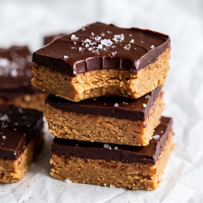 close up of no bake protein bars soft chewy texture with chocolate layer and bite