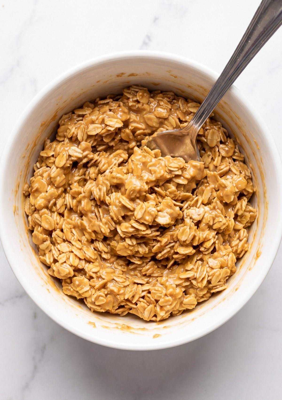 No Bake Oatmeal Bars mixture with oats peanut butter and maple syrup in bowl easy healthy snack recipe