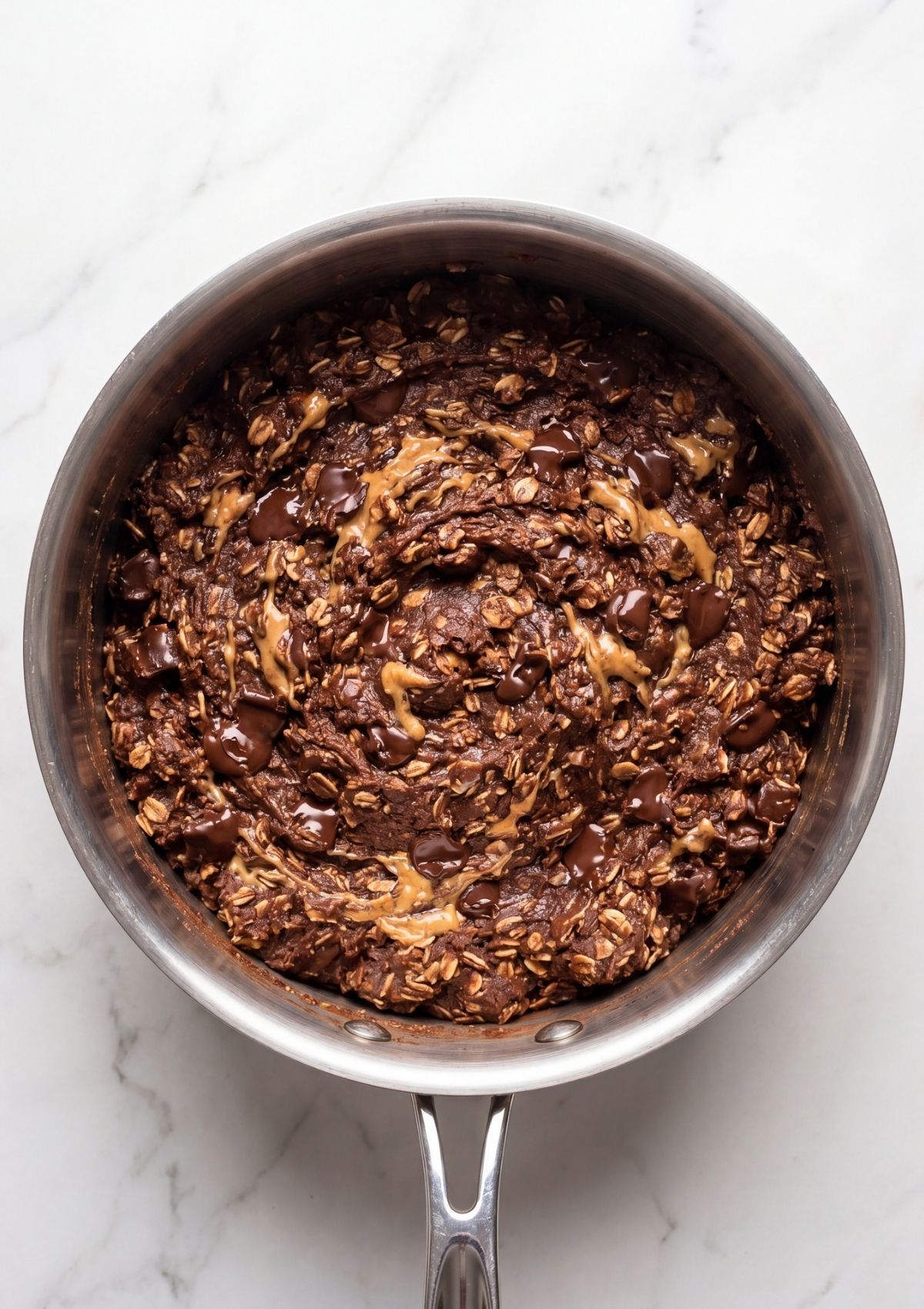 vegan no bake cookies chocolate oat mixture in saucepan with peanut butter step by step