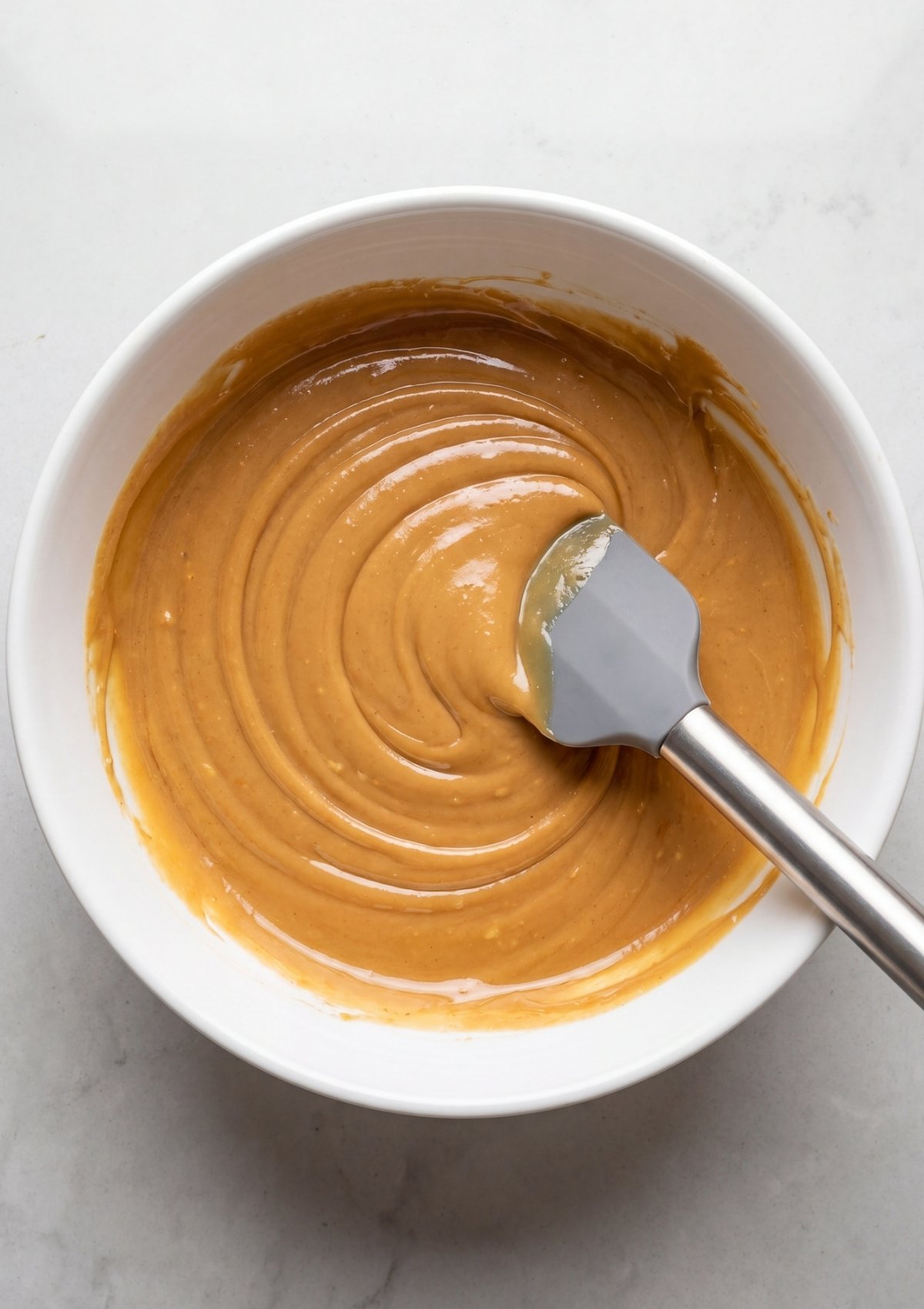 thick peanut butter oatmeal mixture with chocolate chips in bowl for no bake oatmeal bars recipe