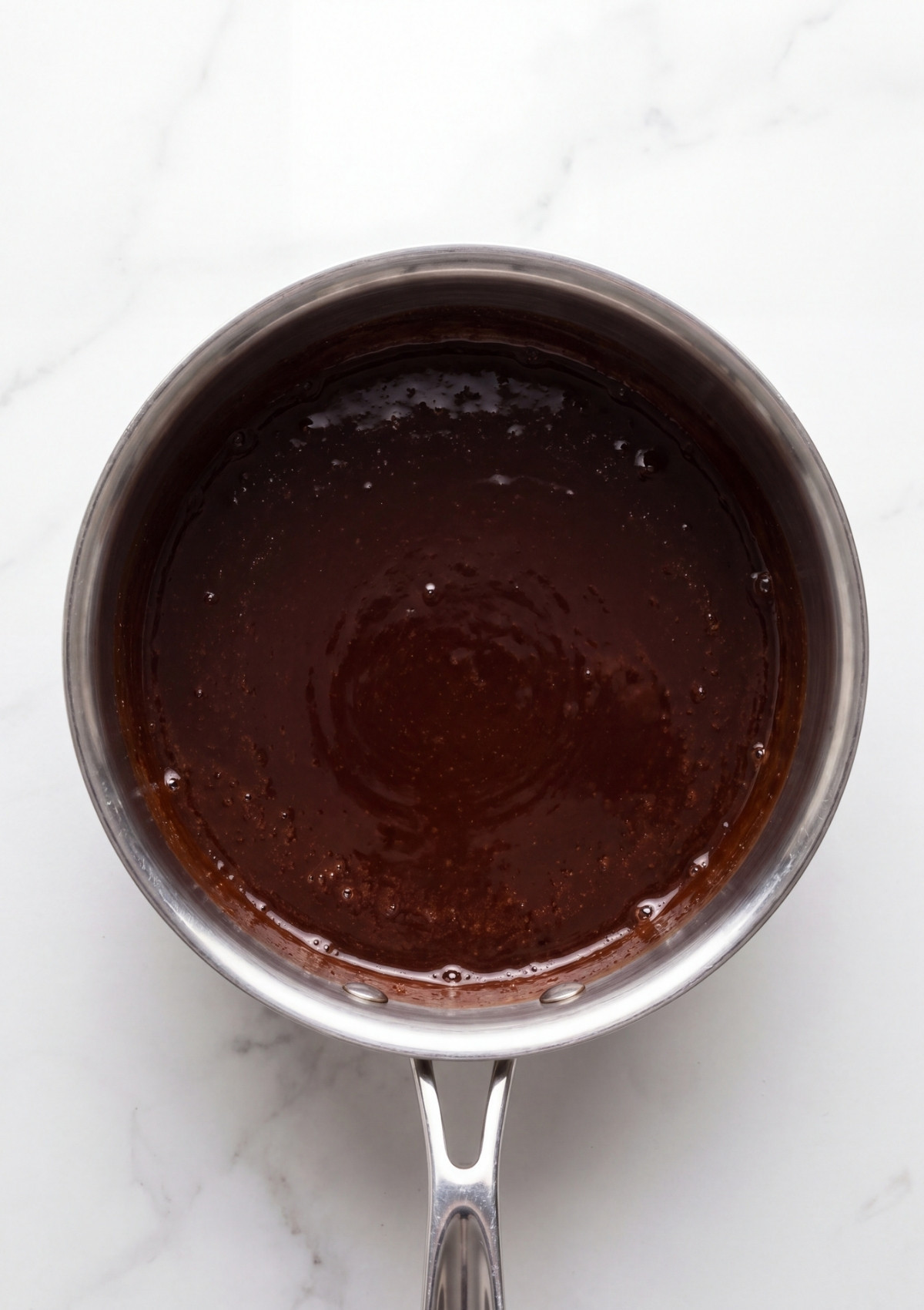 chocolate syrup base cooking in saucepan for vegan no bake cookies easy homemade dessert