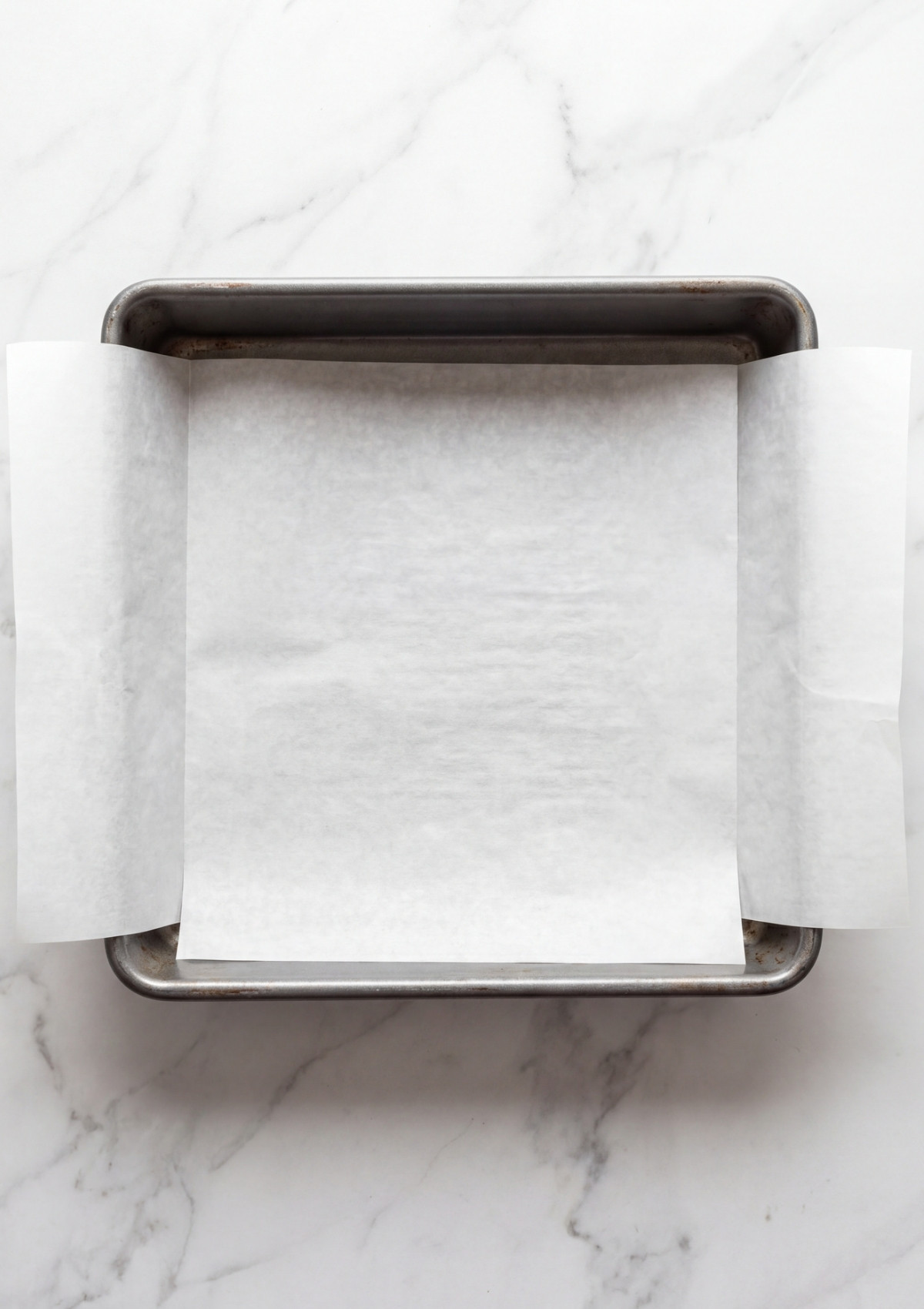 parchment lined baking pan ready for no bake oatmeal peanut butter bars easy meal prep step