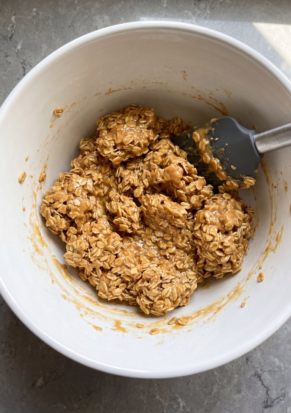 no bake peanut butter oatmeal bars mixture in bowl with oats and peanut butter thick and sticky easy no bake recipe step