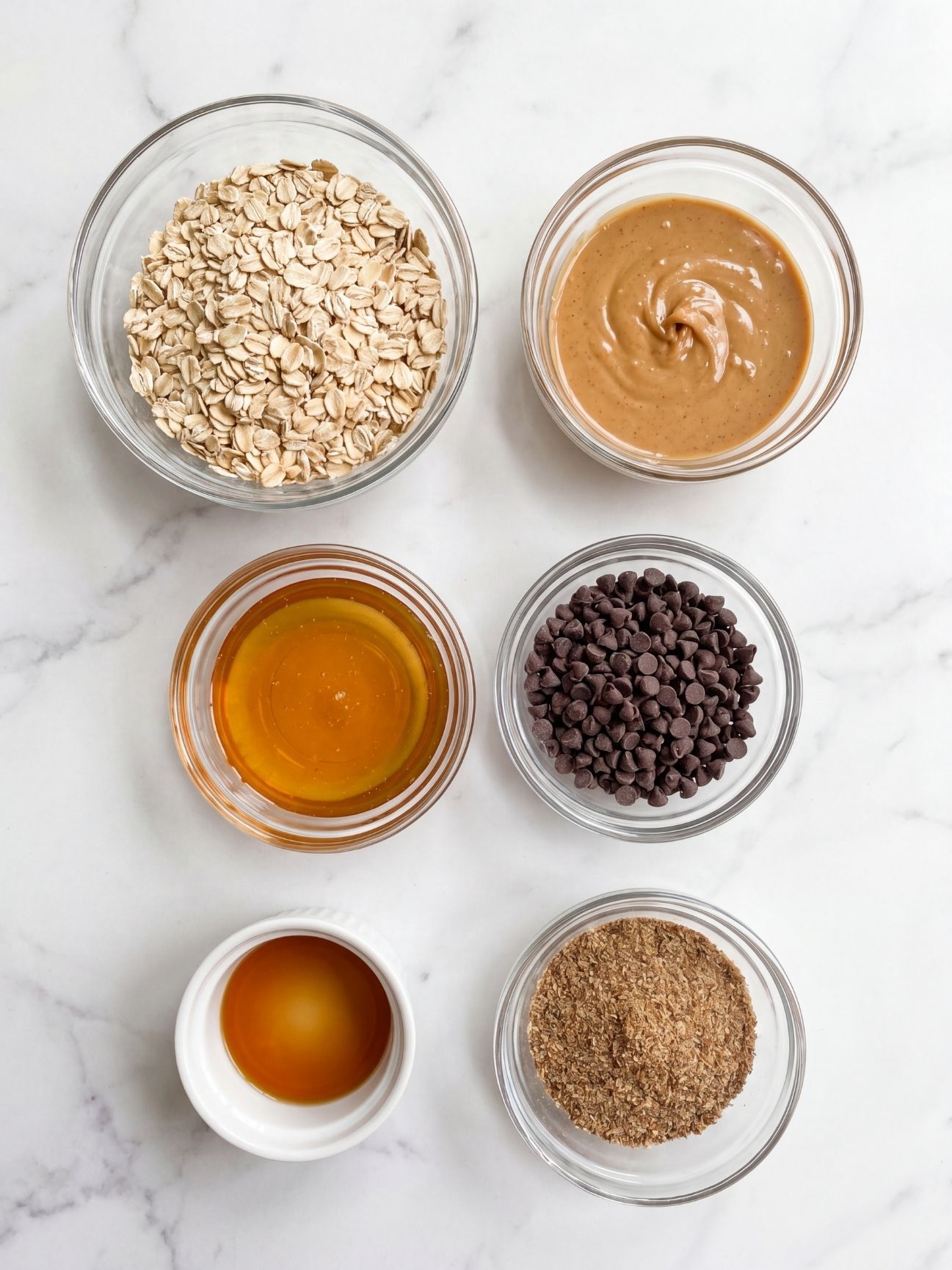 no bake peanut butter oat balls ingredients oats peanut butter honey chocolate chips flaxseed laid out for easy recipe