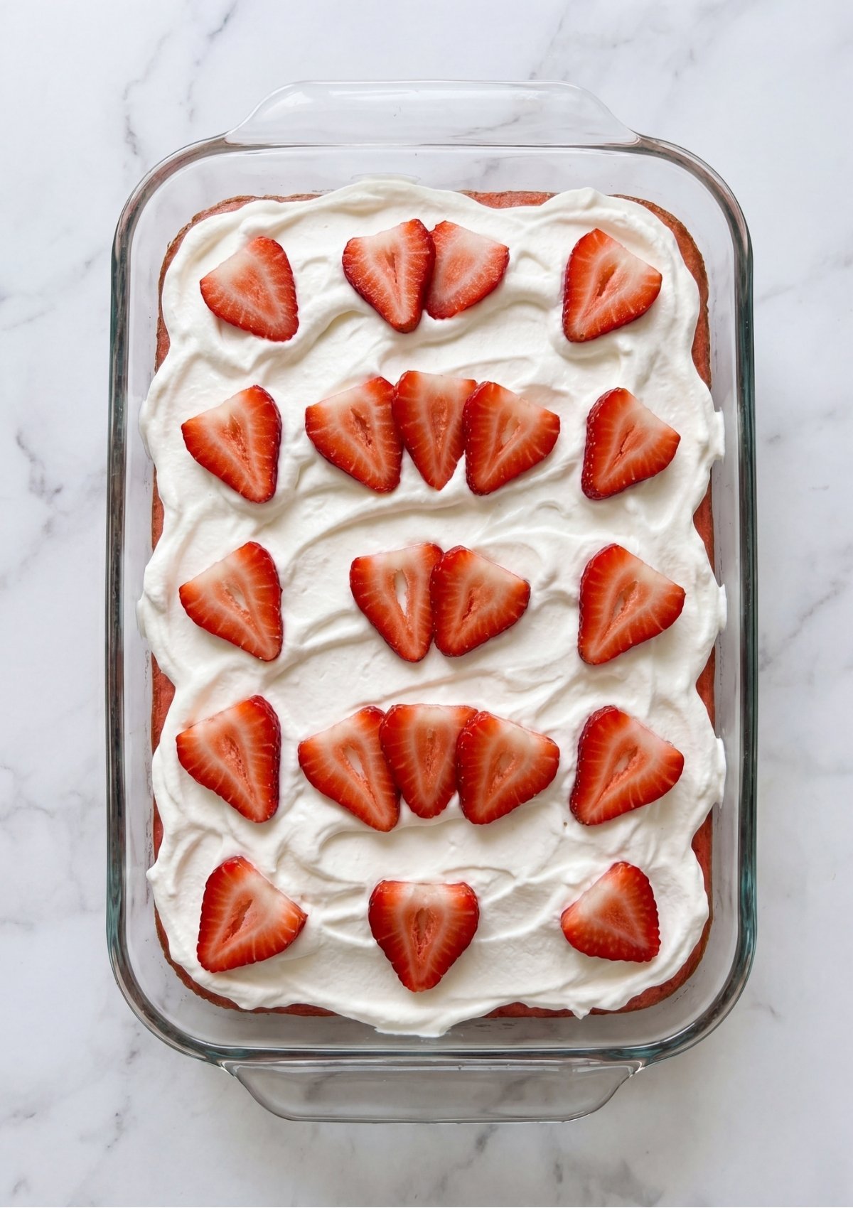 This classic strawberry poke cake is the ultimate easy dessert for your next backyard cookout or family gathering. Made with simple pantry staples, this light and refreshing treat features a moist yellow cake soaked in sweet strawberry gelatin and topped with creamy whipped topping. It is a simple homemade recipe that everyone loves.